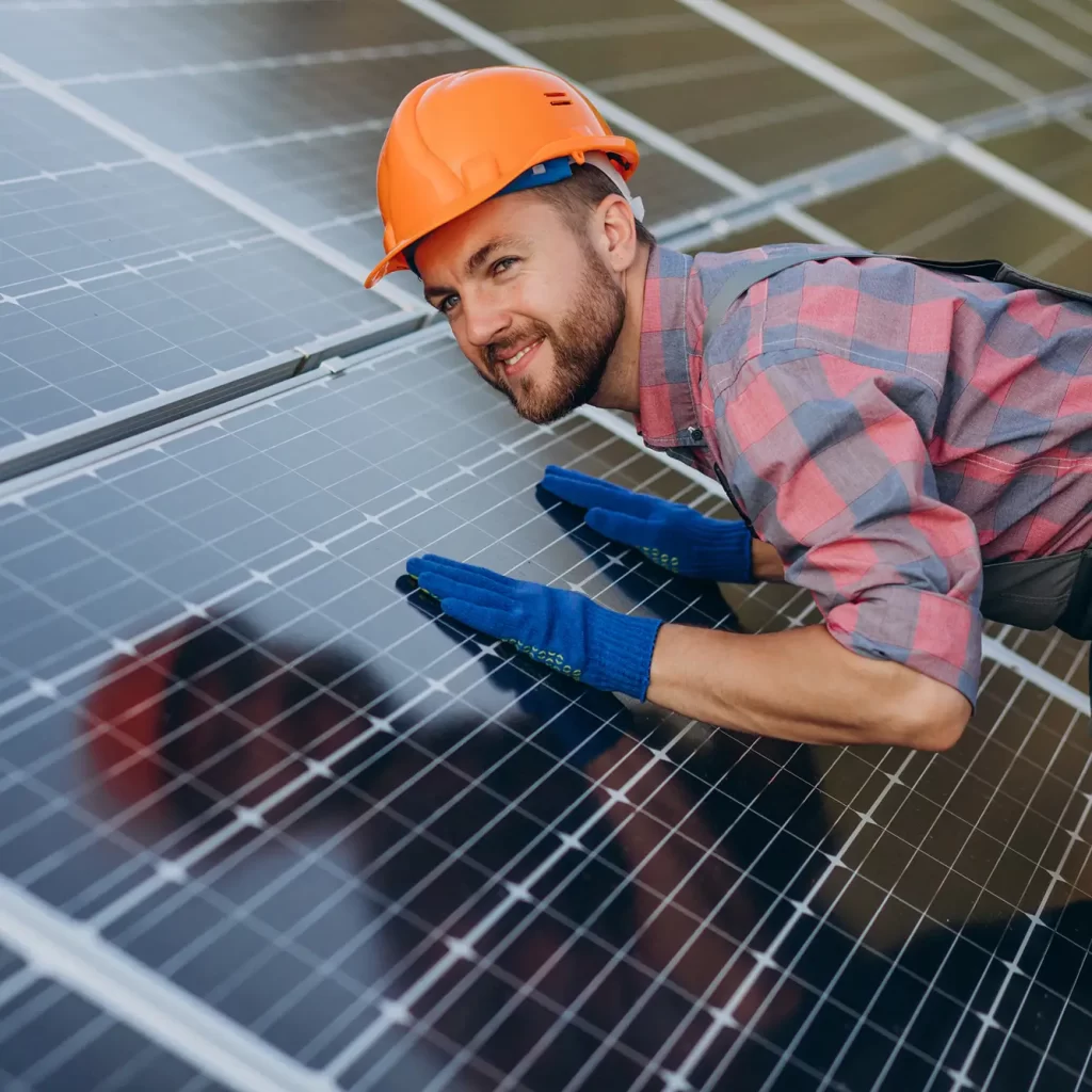 male-worker-cleaning-solar-panels -24x7 Electrical Services